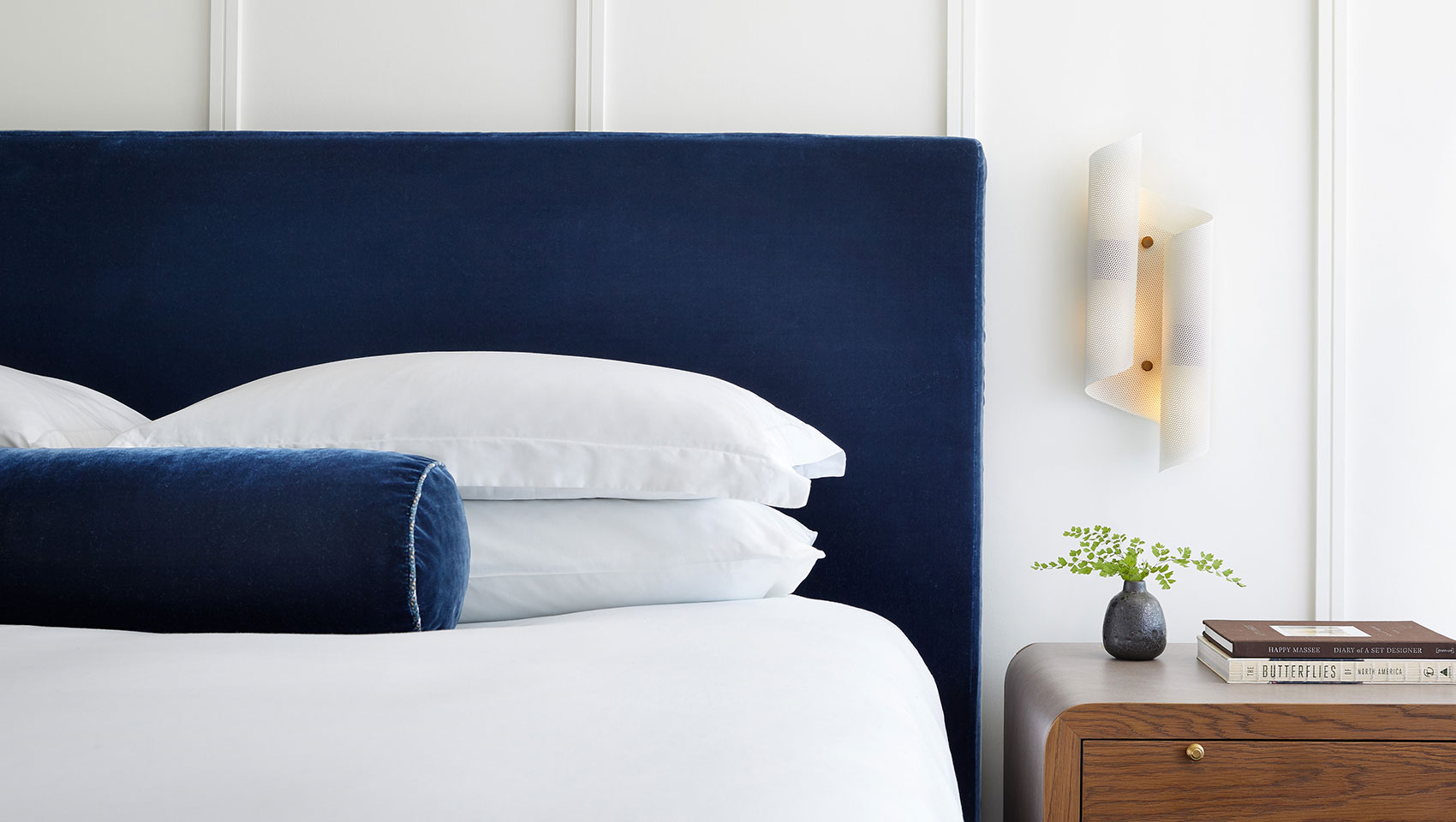 white bed with wooden nightstand