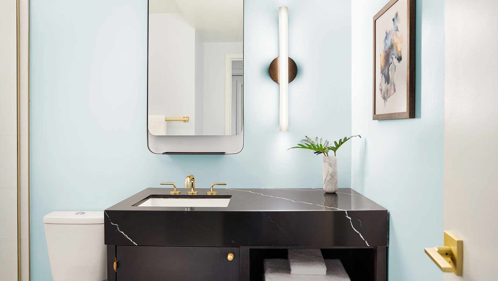 bathroom sink with blue wall and mirror
