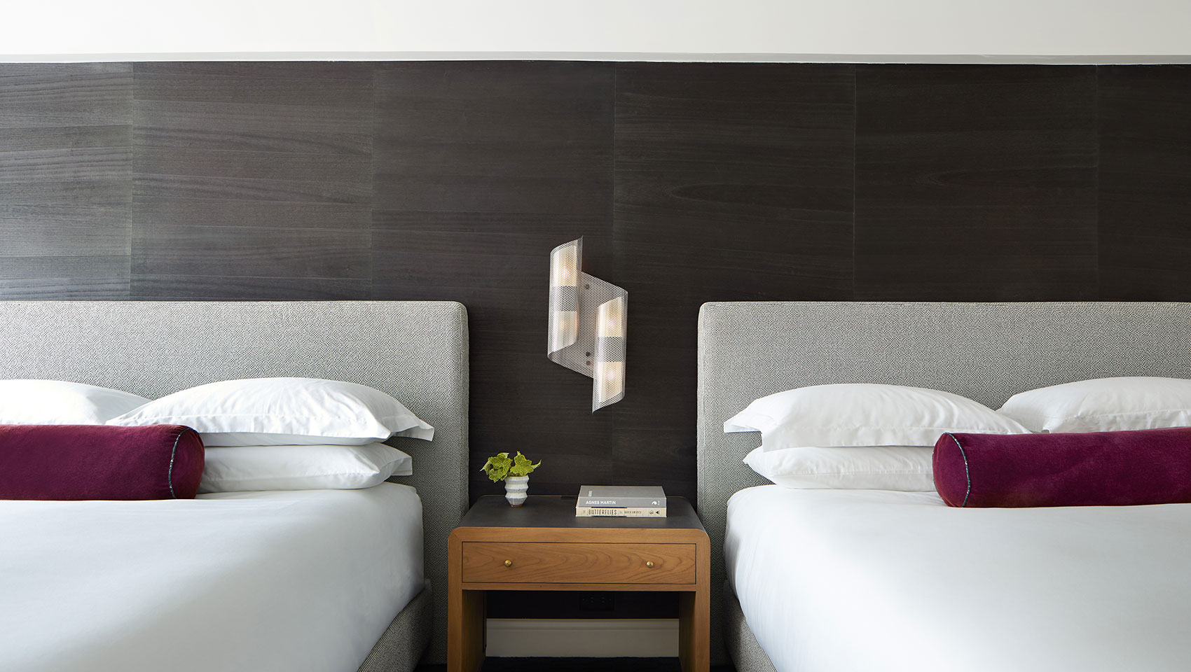 two white queen beds with gray headboards